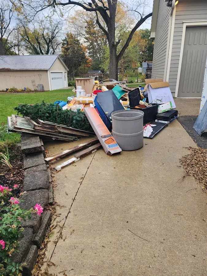 Dumpster being loaded with debris for Estate Cleanout Dumpster Rental in Kingman